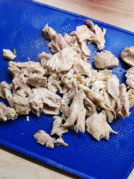 Gezupftes Hähnchenfleisch für den mexikanischen Maiseintopf Pozole